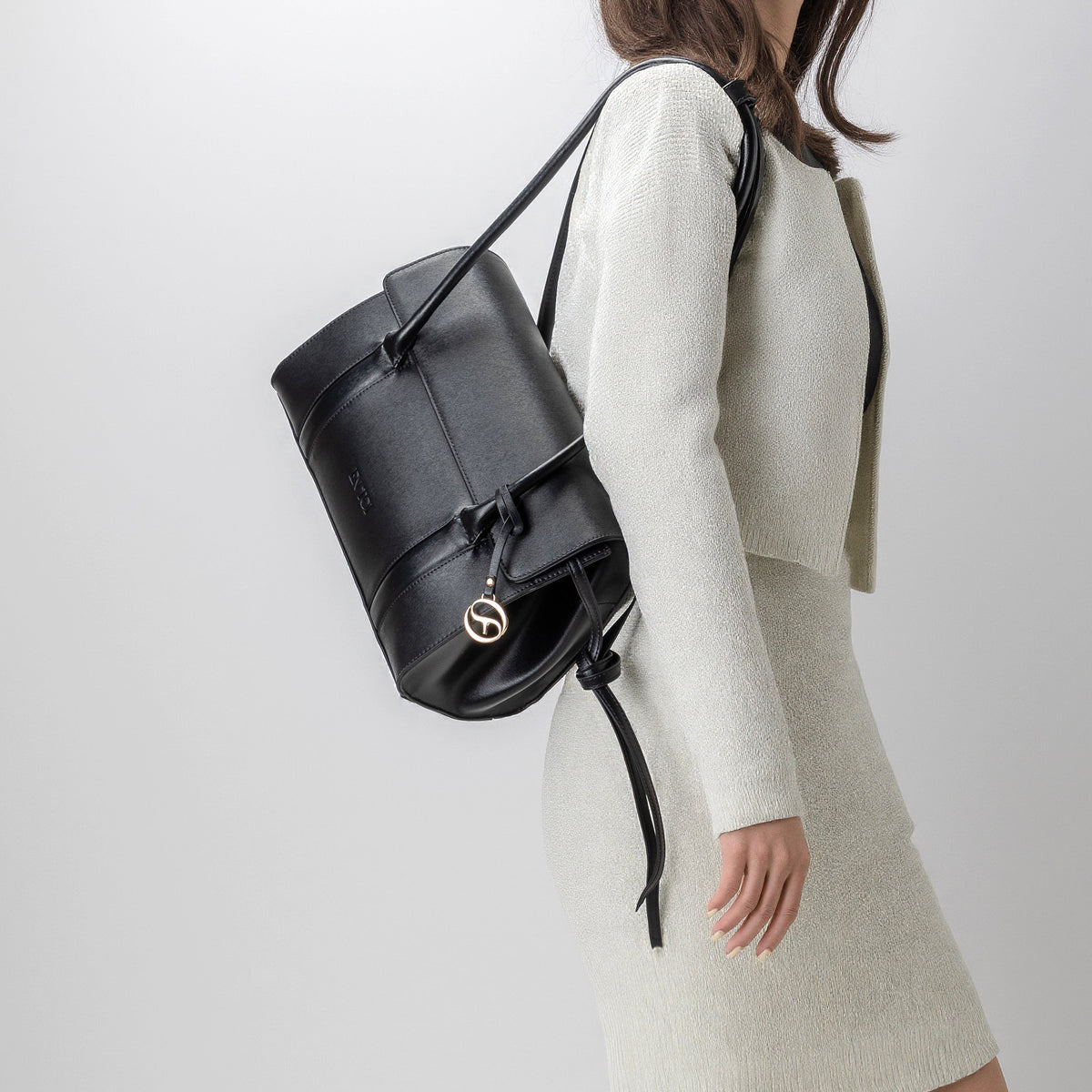 Woman carrying Athens black vegan leather satchel bag by EN TOI